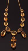 Antique citrine necklace designed as a line of graduated oval cut citrines suspending circular and