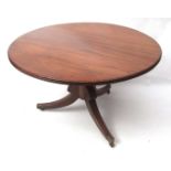 Regency period mahogany circular dining table, with reeded edge, raised on lobed baluster support