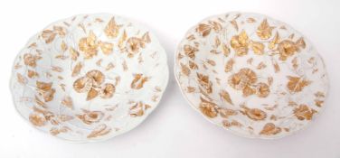 Two Meissen dishes decorated with moulded trailing flowers picked out in gilt, 28cm diam, blue