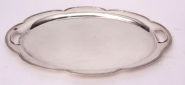 George V two-handled tea tray, lobed oval form with cast and applied rim and polished field with