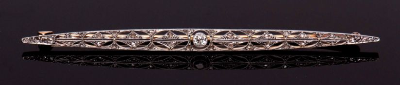 Art Deco precious metal diamond brooch, the pierced elongated plaque, set with a principal collet