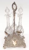 Late 19th century electro-plated decanter stand of triform base with scrolling supports and