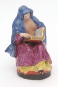 A rare Liverpool (Chaffers) model of a nun reading the Bible, decorated in polychrome enamels, 13cms