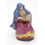 A rare Liverpool (Chaffers) model of a nun reading the Bible, decorated in polychrome enamels, 13cms