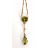 Early 20th century peridot and seed pearl pendant necklace featuring a cushion shaped peridot