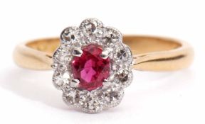 Precious metal, ruby and diamond cluster ring, the oval shaped ruby within a surround of ten small