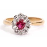 Precious metal, ruby and diamond cluster ring, the oval shaped ruby within a surround of ten small