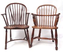 Two 19th century oak/elm stick back Windsor armchairs with solid seats, one with crinoline