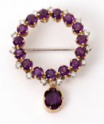 Amethyst and diamond brooch, designed as an openwork circular wreath, alternate set with small