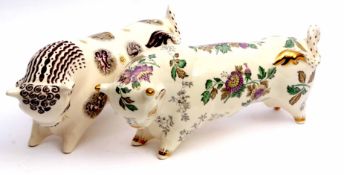 Pair of Wedgwood pottery bulls, one decorated with signs of the Zodiac, the other with a floral