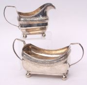 George III Irish sugar basin and milk jug, each of open rectangular form with reeded handles and