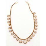 Moonstone necklace, design is a line of graduated circular cut moonstone drops, each set in cut down