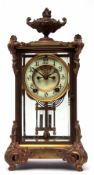 Late 19th/early 20th century American gilt four glass mantel clock, the plinth shaped case