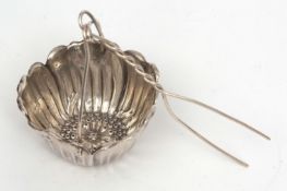 Late 19th century American tea strainer, the bowl modelled in the form of a flower with pierced