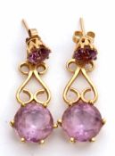 Pair of 18ct gold and amethyst drop earrings, a design with a circular pale amethyst supported on