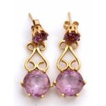 Pair of 18ct gold and amethyst drop earrings, a design with a circular pale amethyst supported on