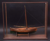 Vintage oak model of a sailing barge with green painted hull, single mast and plain bowsprit in a