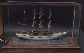 Painted model of a three-masted schooner within a glazed display case, 96cm long