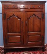 18th century oak housekeeper's cupboard, moulded top over three drawers, two panelled doors below