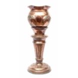 Early 20th century copper jardiniere and stand, the jardiniere applied with raised pierced floral