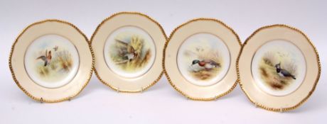 Set of twelve mid-20th century Coalport plates with gadroon gilt rims and painted with game birds