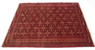 Modern Turkoman rug, multi-gull border and central geometric panel, mainly red field, 190cm x 150cm