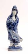 Oriental figure of Guanyin decorated in tones of underglaze blue on a moulded base, 31cm high