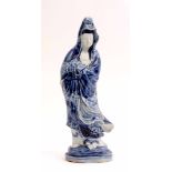 Oriental figure of Guanyin decorated in tones of underglaze blue on a moulded base, 31cm high