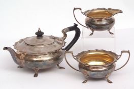 George V three-piece tea set of compressed circular form, and each with cast and applied rims and