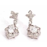 Pair of precious metal and diamond cluster drop earrings, the centre diamond of oval shape, 0.20ct