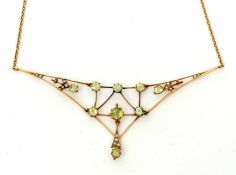 Early 20th century peridot and seed pearl articulated necklace, a spider's web design set with