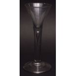 18th century wine glass with plain conical bowl and air drop stem terminating in a spreading