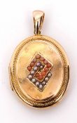 Antique yellow metal oval locket, the centre applied with two overlapping geometric shapes, one