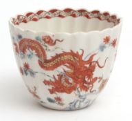 Chelsea fluted beaker decorated in the Kakiemon palette with a celestial dragon entwined around