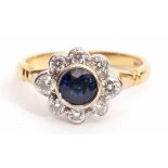 18ct gold, sapphire and diamond cluster ring, the circular shaped faceted sapphire collet set within