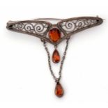 Art Nouveau Murle Bennett filigree brooch having a central cognac citrine suspending two tear drop