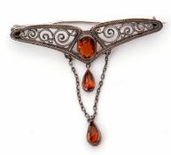 Art Nouveau Murle Bennett filigree brooch having a central cognac citrine suspending two tear drop