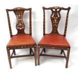 Two Chippendale style walnut dining chairs, each with pierced splat backs and both profusely