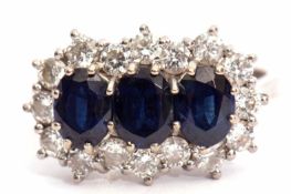 Precious metal sapphire and diamond cluster ring, having three oval shaped sapphires within a