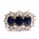 Precious metal sapphire and diamond cluster ring, having three oval shaped sapphires within a