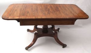 Regency period rosewood sofa table, the cross-banded top applied at either end with drop flaps