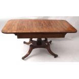 Regency period rosewood sofa table, the cross-banded top applied at either end with drop flaps