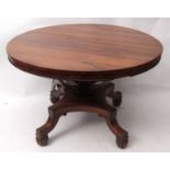 Early 19th century rosewood circular dining table raised on swept open work column, terminating in a