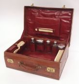 George V stitched leather fitted dressing case of rectangular form with hinged and initialled