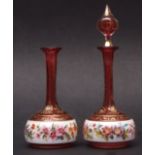 Pair of decorative cranberry glass overlaid scent bottles (one with missing stopper), the bodies