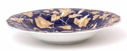 19th century Meissen dish, the blue ground with moulded floral design, the flowers picked out in