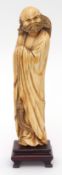 Fine Chinese ivory carving of a bearded immortal shrouded in his robes and holding a whisk, on