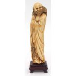 Fine Chinese ivory carving of a bearded immortal shrouded in his robes and holding a whisk, on