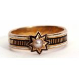 Victorian Memoriam ring featuring a small seed pearl in a star engraved black enamel setting,