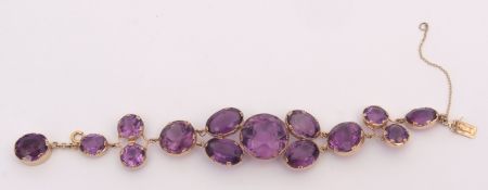 9ct gold and amethyst coloured glass cluster bracelet, having a circular and oval cut graduated